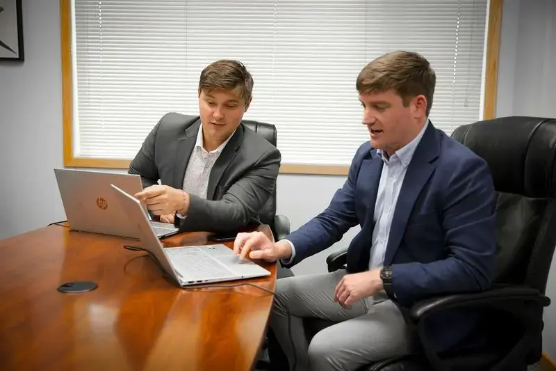 Two people looking at a laptop