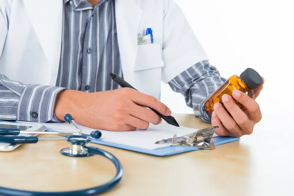 Doctor writing prescription details